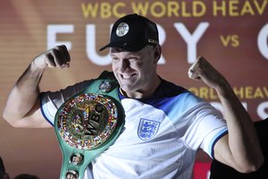 Tyson Fury poses with his championship belt