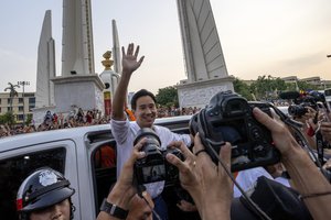 Pita Limjaroenrat, center, (white shirt) leader of Move Forward Party, waves to his supporters, in Bangkok, Monday, May 15, 2023. Fresh off a stunning election victory in which they together captured a majority of seats in the House of Representatives, Thailand's top two opposition parties began planning Monday for the next stage in their bid to replace the military-dominated government. (AP Photo/Wason Wanichakorn)