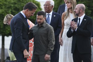 From left, Netherland's Prime Minister Mark Rutte, Ukraine's President Volodymyr Zelenskyy and European Council President Charles Michel at a group photo during a social dinner as part of the program of the NATO summit in Vilnius, Lithuania, Tuesday, July 11, 2023