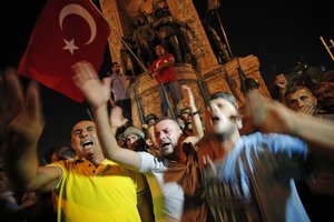 Supporters of Turkey's President Recep Tayyip Erdogan, protest in front of soldiers in Istanbul's Taksim square, early Saturday, July 16, 2016. Turkey's prime minister says a group within Turkey's military has engaged in what appeared to be an attempted coup. Binali Yildirim told NTV television: "it is correct that there was an attempt." (AP Photo/Emrah Gurel)