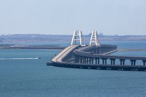 A freight train runs on rails of a railway link of the Crimean Bridge connecting Russian mainland and Crimean peninsula over the Kerch Strait not far from Kerch, Crimea, on Monday, July 17, 2023