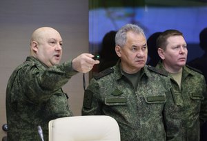 Gen. Sergei Surovikin, left, and Minister Sergei Shoigu , center, attend the meeting with Vladimir Putin