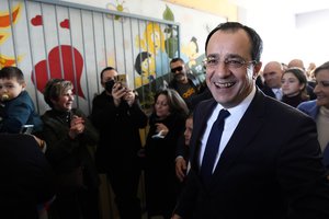 Presidential candidate Nikos Christodoulides smiles as walks with his supporters after casting his vote during the presidential elections in Geroskipou in south west coastal city of Paphos, Cyprus, Sunday, Feb. 12, 2023.