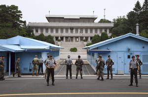 Soldiers of South Korea and the U.S. stand guard during a commemorative ceremony for the 64th anniversary of the signing of the Korean War Armistice Agreement at the truce village of Panmunjom in the Demilitarized Zone (DMZ) dividing the two Koreas, on July 27, 2017