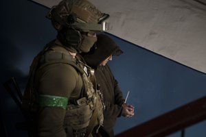 File - A Security Service of Ukraine (SBU) serviceman detains a man suspected to be a Russian collaborator in Kharkiv, Ukraine, Thursday, April 14, 2022.