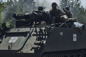 Ukrainian soldiers ride an M-113 APC on the frontline in the Zaporizhzhia region, Ukraine, Saturday, July 1, 2023