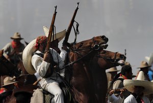 Soldiers re-enact a revolution battle as part of Mexican Revolution 101th anniversary celebrations in Mexico City