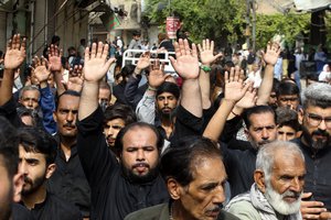 People participate in the Ashoura procession in Peshawar, Pakistan