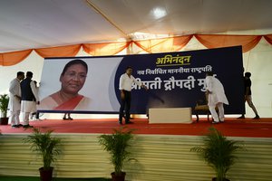 Workers put up a giant hoarding of Droupadi Murmu for her felicitation, before she was announced as the country's new President, in New Delhi, India, Thursday, July 21, 2022.