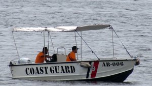 The Philippine Coast Guard Boat AB-006 that is helping monitor and guard the area around the CG-53 USS Mobile Bay Cruiser