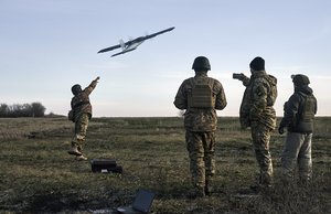 Ukrainian soldiers launch a drone at Russian positions near Bakhmut, Donetsk region, Ukraine, Thursday, Dec. 15, 2022