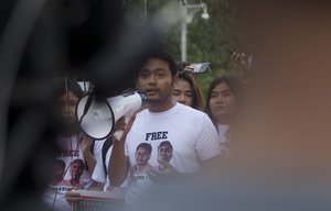 Activist Maung Saung Kha speaks during a rally to mark one year anniversary