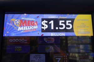 An electronic sign of Mega Millions on a scratch off dispenser, is displayed for players