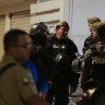 lice guard the hospital where several of the injured were taken after an attack against presidential candidate Fernando Villavicencio in Quito.