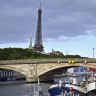 A crane is used to dismantle the starting line after the cancellation of the Open Water Swimming World Cup on the Seine in Paris.