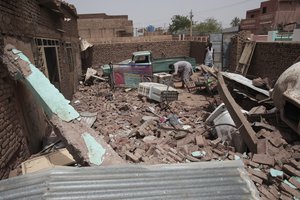 A man cleans debris of a house hit in recent fighting in Khartoum, Sudan, on April 25, 2023