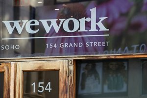 This Oct. 15, 2019 file photo shows a WeWork logo at the entrance to one of their office spaces in the SoHo neighborhood of New York