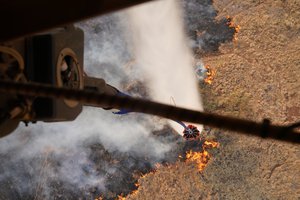 Two Hawaii Army National Guard CH47 Chinook perform aerial water bucket drops on the Island of Maui to assist the fight of wildfires, Maui, Hawaii, August 09, 2023. The two air crews performed 58 total bucket drops in 5 hours in up country Maui totaling over one hundred thousand gallons dropped on the fires.