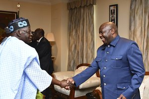 Nigeria's President, Bola Ahmed Tinubu, left, shake hands with Burundi's President Evariste Ndayishimiye, right, before an ECOWAS meeting in Abuja, Nigeria, Thursday, Aug. 10, 2023