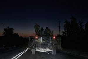 Ukrainian soldiers ride an APC at the front line near Bakhmut, one of the longest battles with Russian troops, Donetsk region, Ukraine, Monday, Aug. 14, 2023