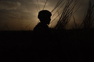 US Army Sgt. Nathaniel Patterson alks ahead of his squad to make sure things are safe ahead in Mahmudiyah, Iraq