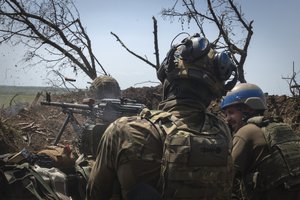 Ukrainian soldiers fire toward Russian position from a trench on the frontline in Zaporizhzhia region, Ukraine, Friday, June 23, 2023