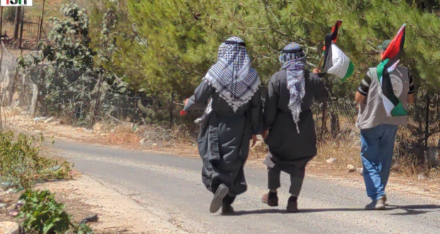 Villagers march to their spring in Qaryout