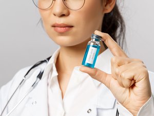 Close-Up Shot of a Woman Holding a Covid-19 Vaccine