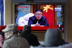 FILE - In this April 21, 2020, file photo, people watch a TV screen showing a news program reporting about North Korean leader Kim Jong Un with a file image at the Seoul Railway Station in Seoul, South Korea.