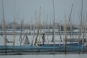 A fisherman watches rescue operations where a passenger boat capsized in Binangonan, Rizal province, Philippines on Friday, July 28, 2023.