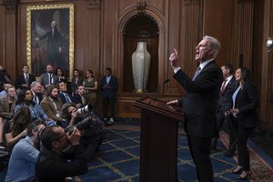 Speaker of the House Kevin McCarthy, R-Calif., pauses as he addresses reporters about efforts to pass appropriations bills and avert a looming government shutdown, at the Capitol in Washington, Friday, Sept. 29, 2023. He is joined at right by House Homeland Security Chair Mark Green, R-Tenn., and Rep. Monica de la Cruz, R-Texas.