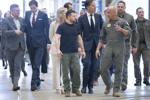 Volodymyr Zelenskyy and Mark Rutte, listen to an F-16 fighter jet pilot in Eindhoven, Netherlands