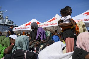 File - Migrants wait to be transferred from Lampedusa Island, Italy, Friday, Sept. 15, 2023. Lampedusa, which is closer to Africa than the Italian mainland, has been overwhelmed this week by thousands of people hoping to reach Europe from Tunisia, which has replaced Libya as the main base of operations for migrant smuggling operations in the Mediterranean.