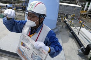 This photo taken during the tour of the treated water dilution and discharge facility for foreign media shows TEPCO official Kenichi Takahara explains to the media on the discharge tunnel, part of the facility for the releasing treated radioactive water to sea from the Fukushima Daiichi nuclear power plant, operated by Tokyo Electric Power Company Holdings (TEPCO), in Futaba town, northeastern Japan, Sunday, Aug. 27, 2023.