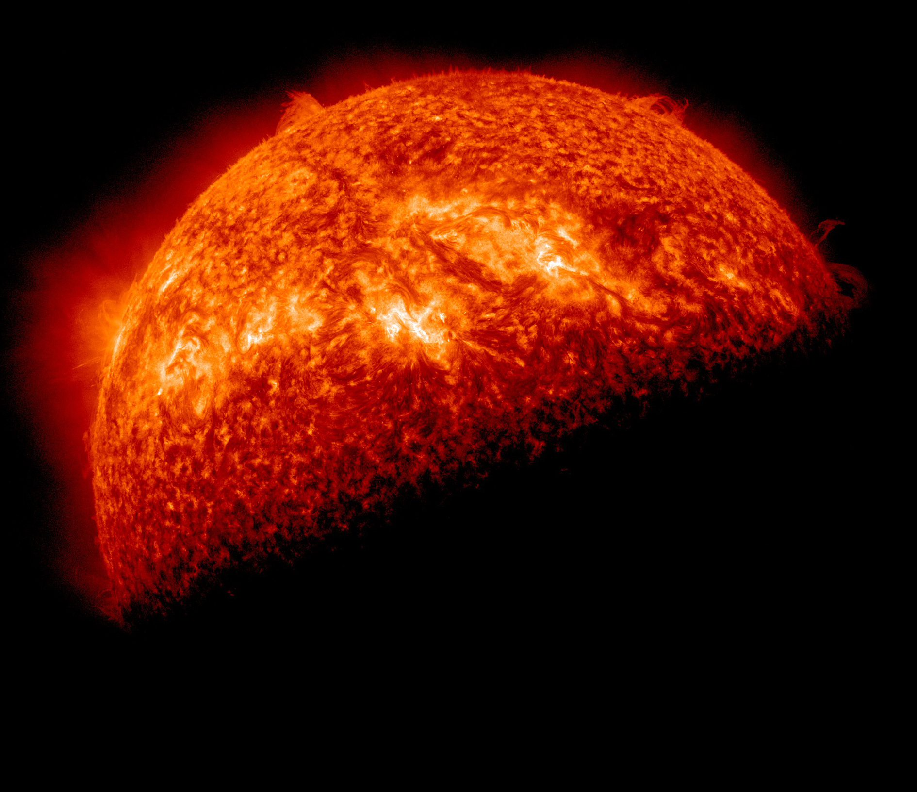 Black space surrounds the Sun, which glows and swirls in red, orange, and spots of yellow and is shrouded by the shadow of Earth. Eruptions spot the edges of the star, sending material into space.⁣ Credit: NASA/GSFC/SDO⁣