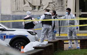 French police officers from the forensic service work in front of the Gambetta high school in Arras, northeastern France