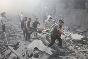 Palestinians evacuate wounded people after an Israeli airstrike in Rafah refugee camp, southern Gaza Strip