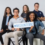 A group of students holding a sign that reads #nasainterns