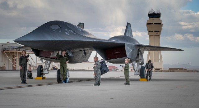 Children walk around the Darkstar prop made for the Top Gun: Maverick. The prop was on display at the 2022 Aerospace Valley Open House, Air Show, & STEM Expo in Edwards, California.