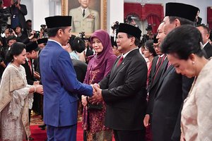 President of Indonesia, Joko Widodo shakes hands with Prabowo Subianto after inauguration of the ministers in Onward Indonesia Cabinet