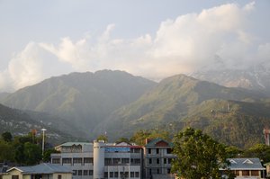 Himalaya horizon - this aerial view of the Himalaya mountains and clouds in the distant horizon, showing part of Dharamshala town and Mcleod Ganj, H.P, India