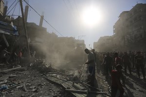 Palestinians look for survivors after an Israeli airstrike in Rafah, Gaza Strip, Thursday, Oct. 26, 2023.