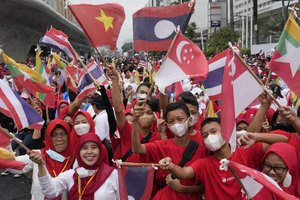 People gather waving ASEAN member country flags during Kick Off 2023 ASEAN Indonesian Chairmanship in Jakarta, Indonesia