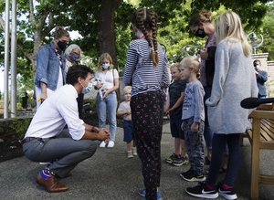 Justin Trudeau talks to family and friends as he leaves a campaign stop in Victoria, B.C.