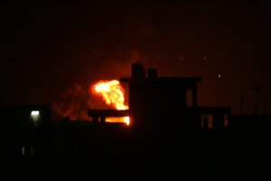 Fire rises during an explosion following an Israeli strike on the border tunnels between Egypt and Rafah in the southern Gaza Strip. In a backdrop of airstrikes and mounting casualties, American efforts to negotiate a cease-fire in the latest Gaza fighting between Israel and Hamas continues. Photo by Ahmed Deeb / WN