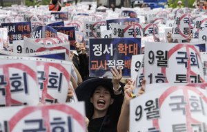 A teacher shouts slogans during a rally to demand the better protection of their rights near the National Assembly in Seoul, South Korea