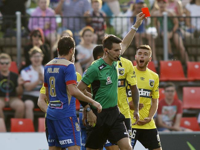 Referee Jonathan Barreiro hands out a red card to Liam Rose.