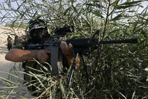 Palestinian militants from the Popular Resistance Movement participate in a training session in the southern Gaza Strip town of Khan Younis on October .01,2011. Israel on Tuesday approved construction of 1,100 homes for Jews on the annexed land in the West Bank, a move that could complicate international efforts to renew peace talks and defuse a crisis over a Palestinian statehood bid at the United Nations. Photo by Ahmed Deeb/WN