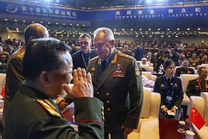 Russian Defense Minister Sergei Shoigu, center, chats with other attendees as he arrives for the opening ceremony of the 10th Beijing Xiangshan Forum in Beijing, Monday, Oct. 30, 2023. Defense Minister Shoigu said Monday the United States is fueling geopolitical tensions to uphold its "hegemony" and warned of the risk of confrontation between major countries.