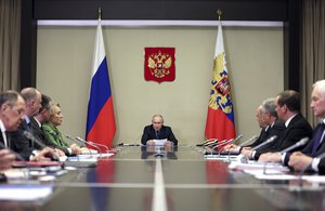 Russian President Vladimir Putin, center, leads the meeting with top security and law enforcement officials in Moscow, Russia, Monday, Oct. 30, 2023